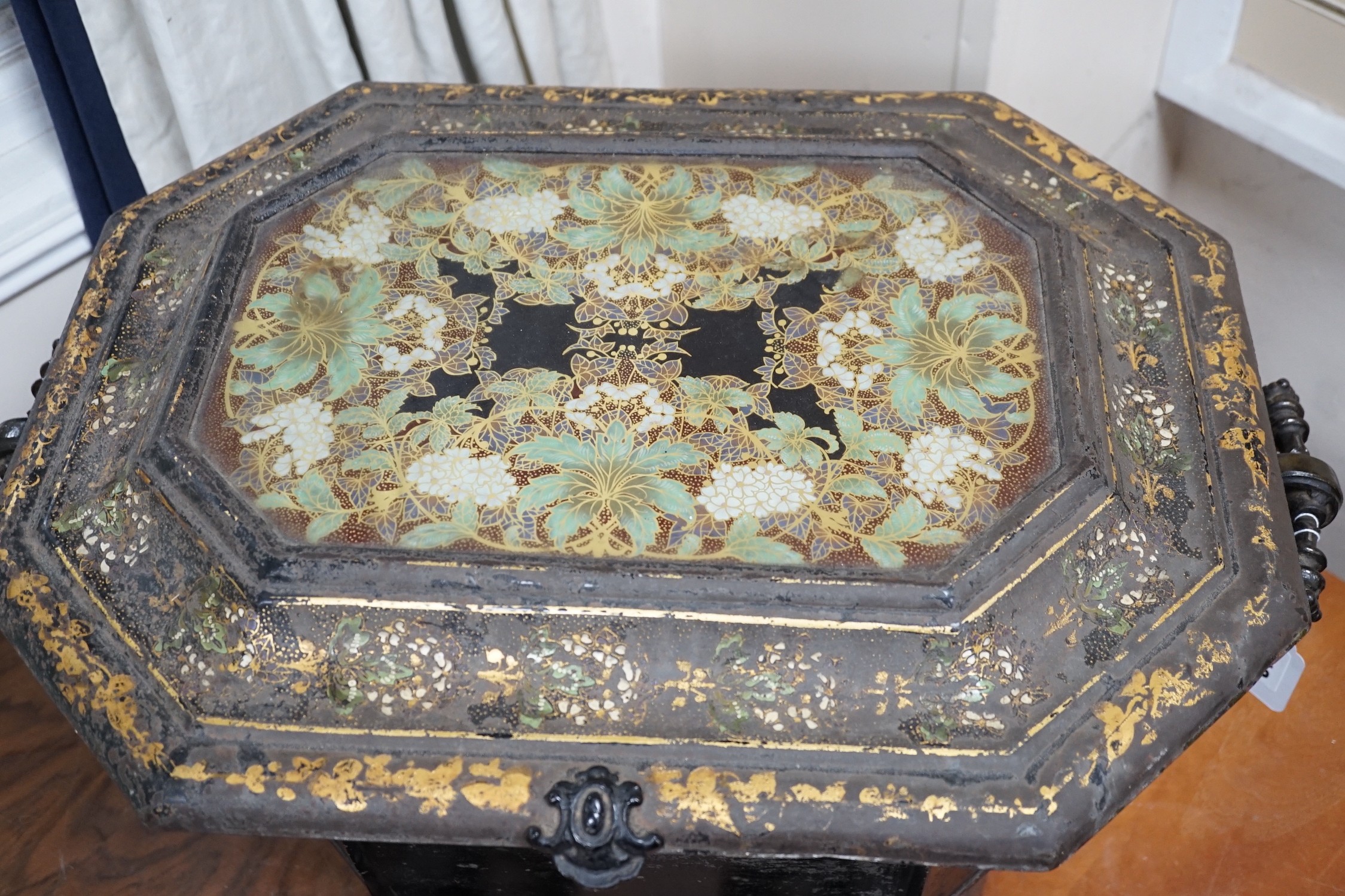 A Victorian gilt lacquer coal scuttle on wheels with glass inset top, 63cm long